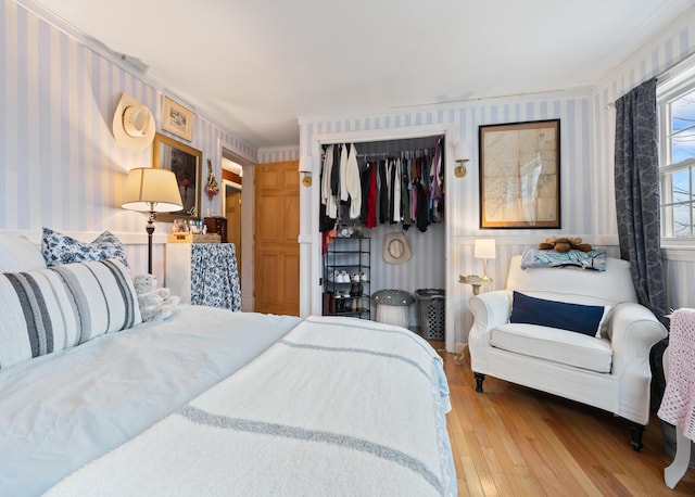 663 Eastbrook Rd, Eastbrook, ME 04634 - bedroom featuring wallpapered walls, wood-type flooring, and a closet
