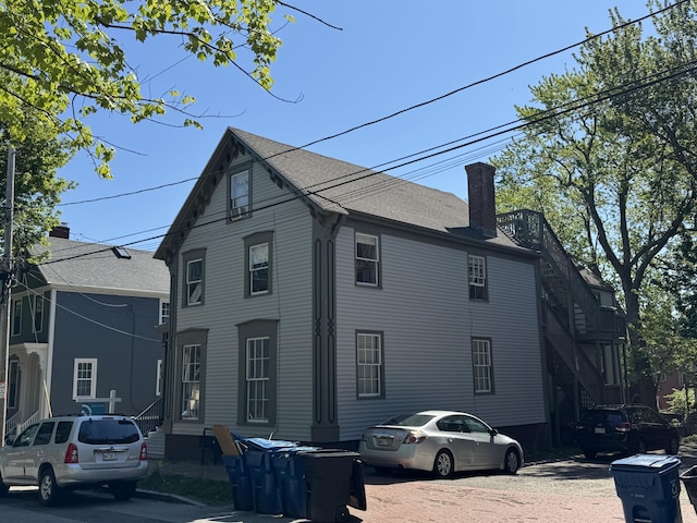 64 Gray St, Portland, ME 04102 - view of side of property with entry steps and a chimney