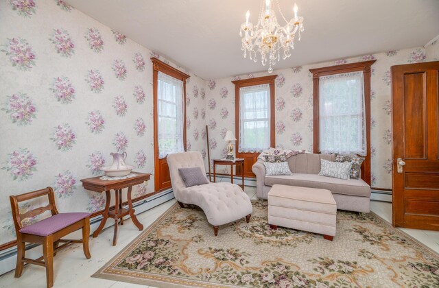 1135 E Pittston Rd, Pittston, ME 04345 - living area featuring wallpapered walls, a baseboard heating unit, and a chandelier