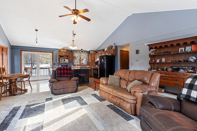 living room featuring a ceiling fan and high vaulted ceiling