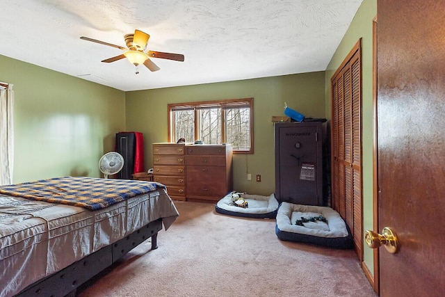 carpeted bedroom featuring a textured ceiling and ceiling fan
