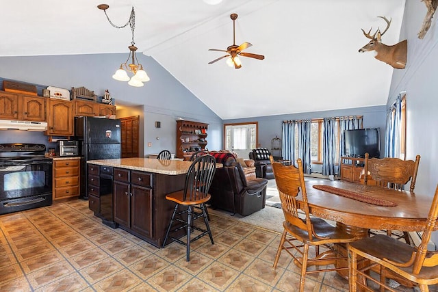 kitchen featuring black appliances, under cabinet range hood, open floor plan, ceiling fan, and hanging light fixtures