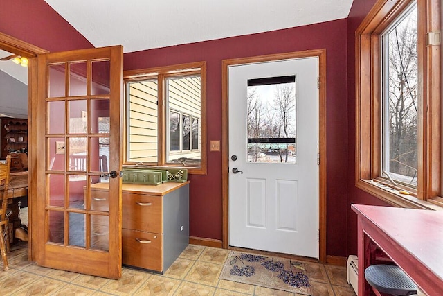 entryway with a healthy amount of sunlight, baseboards, and a baseboard radiator