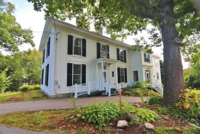 colonial inspired home featuring a chimney