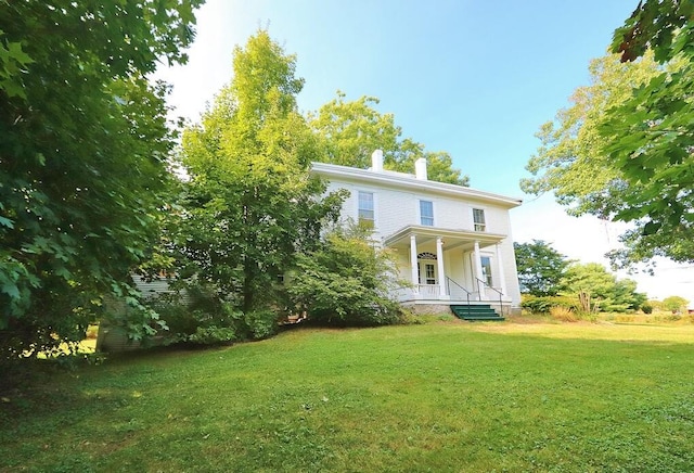 view of front of property with a porch and a front lawn