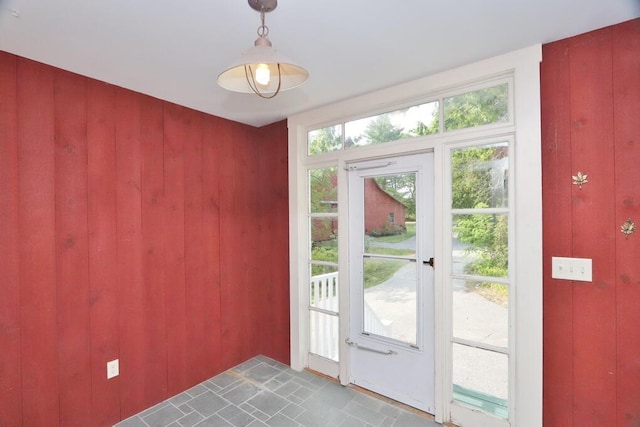 doorway featuring wooden walls