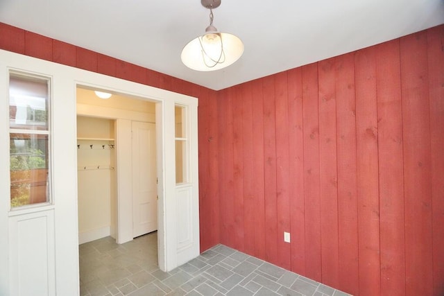 unfurnished bedroom with wood walls