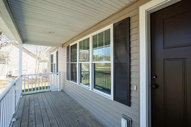 wooden terrace featuring covered porch
