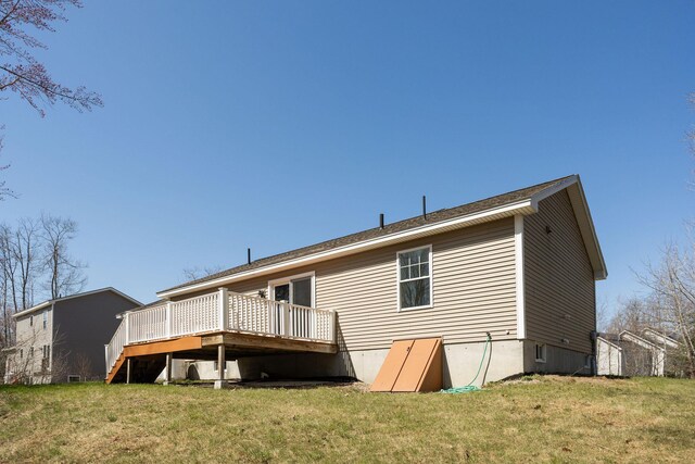 rear view of house with a yard and a deck