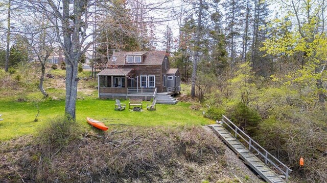 138 Hewes Point Rd, Islesboro, ME 04848 - back of house with a yard, a wooden deck, and a fire pit