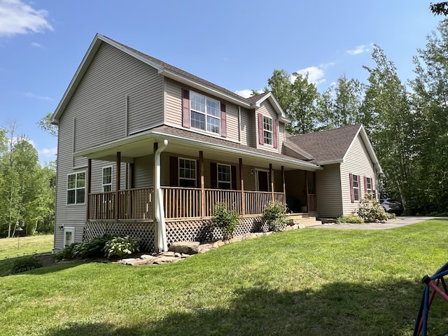 38 Dunston Dr, Glenburn, ME 04401 - view of front of home with covered porch, a front lawn, and roof with shingles