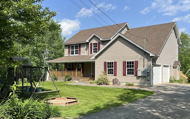 38 Dunston Dr, Glenburn, ME 04401 - view of front of home with driveway, a porch, roof with shingles, a front lawn, and a playground