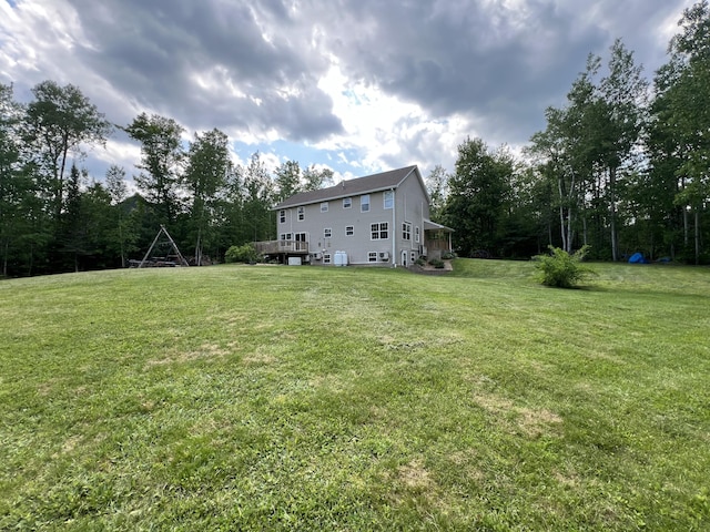 38 Dunston Dr, Glenburn, ME 04401 - view of grassy yard featuring a wooden deck and view of scattered trees