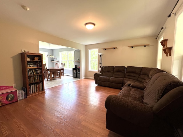 38 Dunston Dr, Glenburn, ME 04401 - living room with wood finished floors and a chandelier