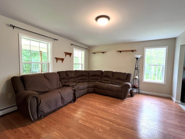 38 Dunston Dr, Glenburn, ME 04401 - living area featuring light wood-type flooring and a baseboard heating unit