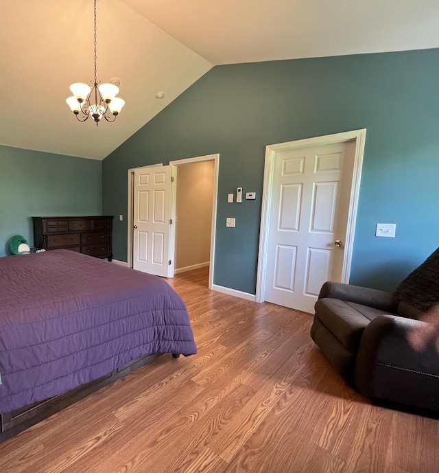 38 Dunston Dr, Glenburn, ME 04401 - bedroom featuring a chandelier, wood finished floors, and high vaulted ceiling