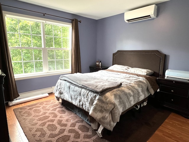 38 Dunston Dr, Glenburn, ME 04401 - bedroom featuring a wall unit AC, wood finished floors, and baseboard heating