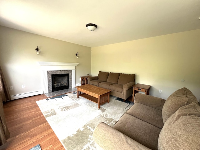 38 Dunston Dr, Glenburn, ME 04401 - living area featuring baseboard heating, wood finished floors, and a premium fireplace