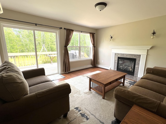 38 Dunston Dr, Glenburn, ME 04401 - living room with a baseboard radiator, a fireplace, and wood finished floors