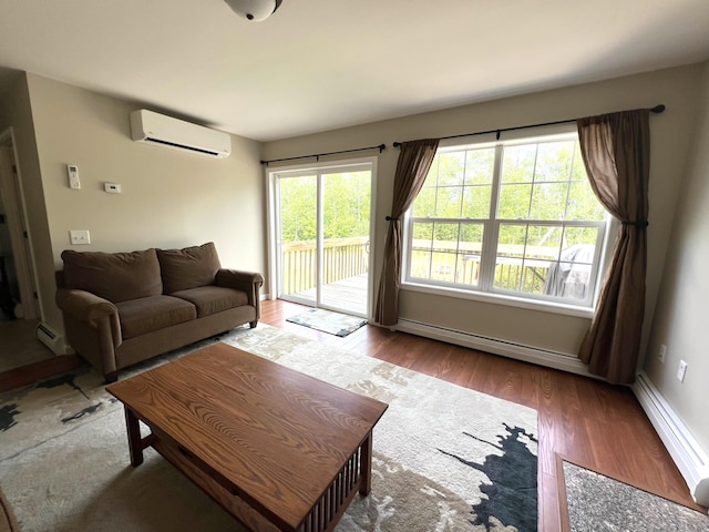 38 Dunston Dr, Glenburn, ME 04401 - living room featuring a wall mounted AC, wood finished floors, baseboard heating, and a baseboard radiator