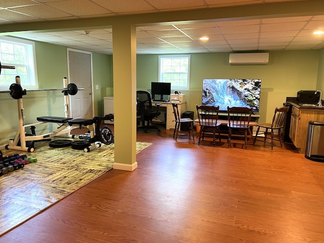 38 Dunston Dr, Glenburn, ME 04401 - exercise room with an AC wall unit, wood finished floors, and a drop ceiling