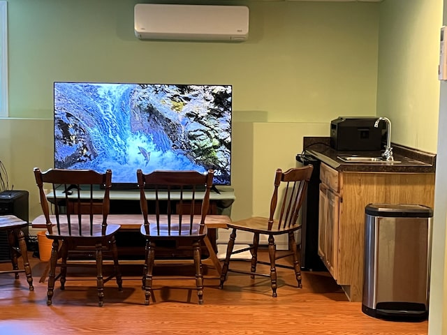 38 Dunston Dr, Glenburn, ME 04401 - dining space featuring a wall unit AC, wet bar, and light wood finished floors