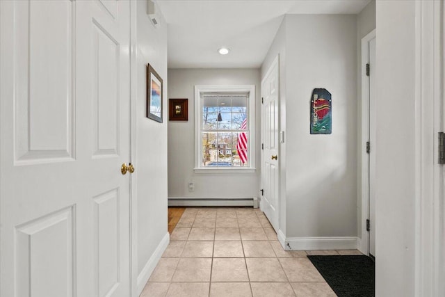 corridor with a baseboard radiator, light tile patterned floors, baseboards, and recessed lighting