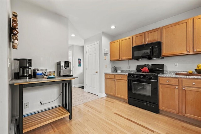 kitchen featuring black appliances, recessed lighting, light countertops, light wood finished floors, and baseboards