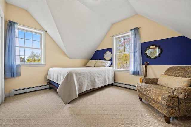 bedroom with baseboard heating, vaulted ceiling, and carpet flooring