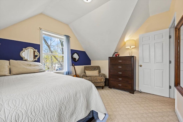 bedroom with vaulted ceiling and carpet floors