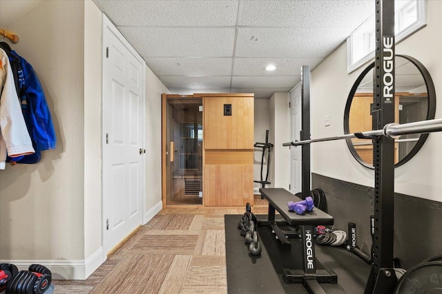 exercise area with a drop ceiling, baseboards, and recessed lighting