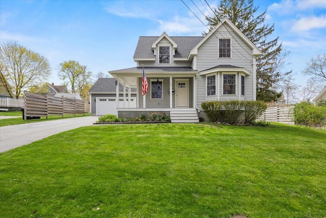 victorian-style house featuring covered porch, driveway, a shingled roof, and an attached garage