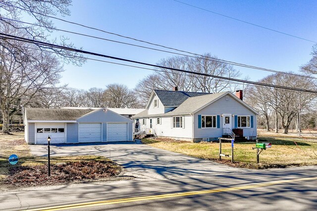 88 Snowball Hill Rd, Bristol, ME 04554 - view of front of home featuring a garage, a chimney, and a front lawn