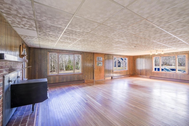 88 Snowball Hill Rd, Bristol, ME 04554 - unfurnished living room with a fireplace, baseboard heating, wood walls, a baseboard heating unit, and hardwood / wood-style floors