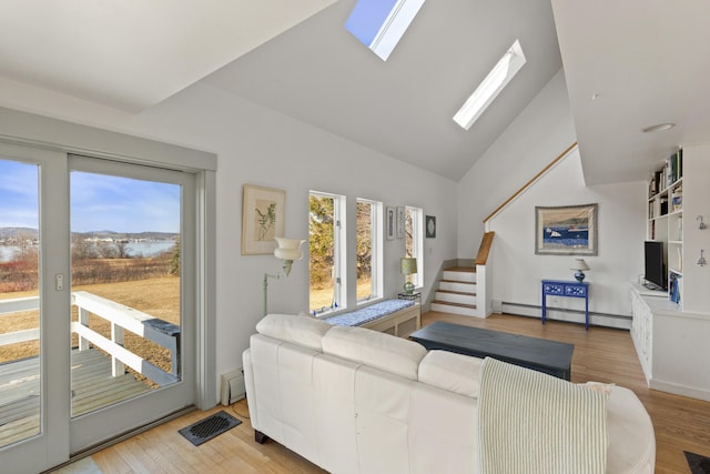 108 N Shore Dr, Owls Head, ME 04854 - living room featuring light wood-style flooring, visible vents, plenty of natural light, and a baseboard radiator