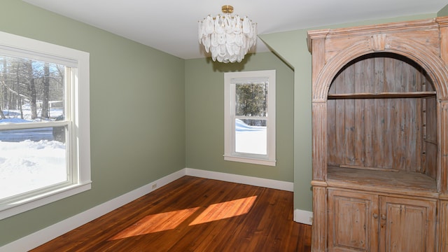 77 Smith St, Fryeburg, ME 04037 - unfurnished dining area with a chandelier, healthy amount of natural light, baseboards, and dark wood-style flooring