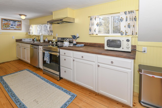 77 Smith St, Fryeburg, ME 04037 - kitchen featuring stainless steel appliances, butcher block countertops, under cabinet range hood, a sink, and light wood-type flooring