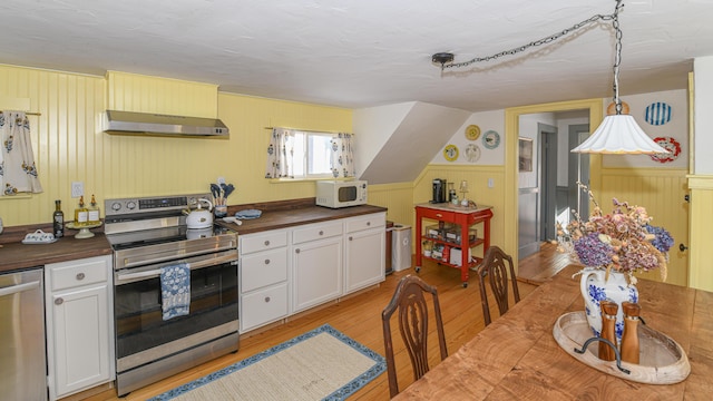 77 Smith St, Fryeburg, ME 04037 - kitchen with appliances with stainless steel finishes, under cabinet range hood, light wood finished floors, butcher block counters, and white cabinetry