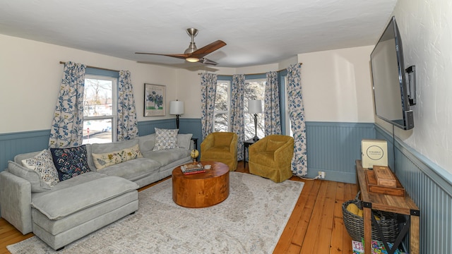 77 Smith St, Fryeburg, ME 04037 - living area with wainscoting, ceiling fan, and hardwood / wood-style floors