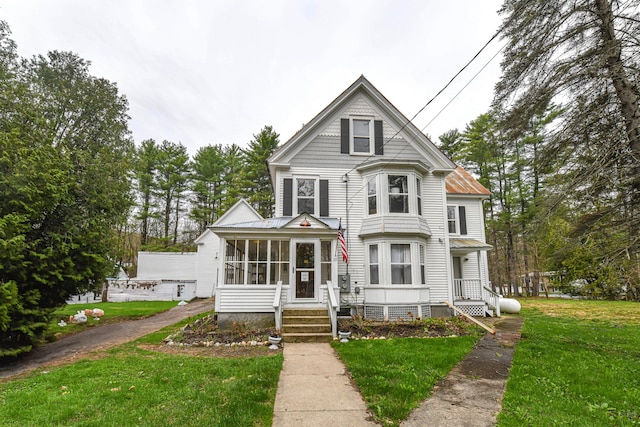 77 Smith St, Fryeburg, ME 04037 - victorian house with a sunroom and a front lawn