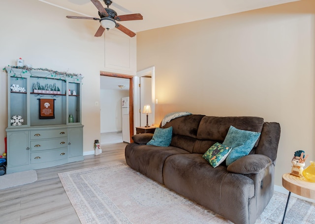 345 Songo Pond Rd, Bethel, ME 04217 - living area with vaulted ceiling, baseboards, ceiling fan, and wood finished floors