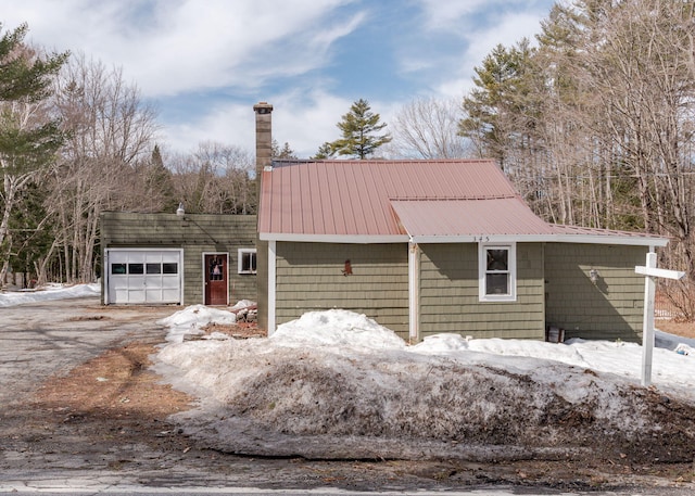 345 Songo Pond Rd, Bethel, ME 04217 - view of front facade with a garage, driveway, and a chimney