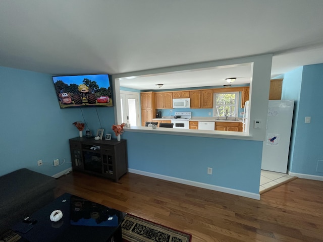 6 Alder Rd, Naples, ME 04055 - kitchen with white appliances, wood finished floors, a sink, and light countertops