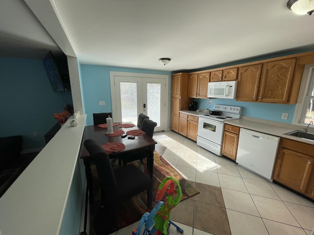 6 Alder Rd, Naples, ME 04055 - kitchen featuring white appliances, french doors, light countertops, and brown cabinets