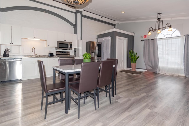 dining area featuring recessed lighting and light wood-style flooring