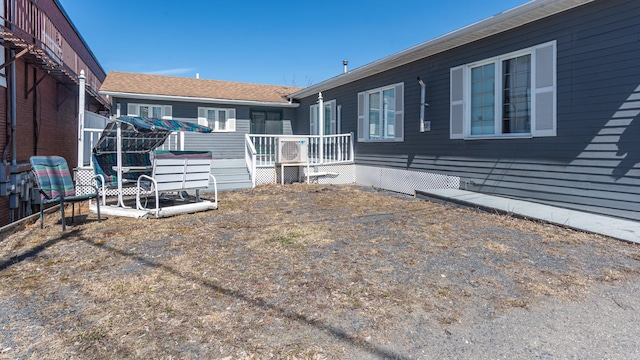 back of house featuring a wooden deck