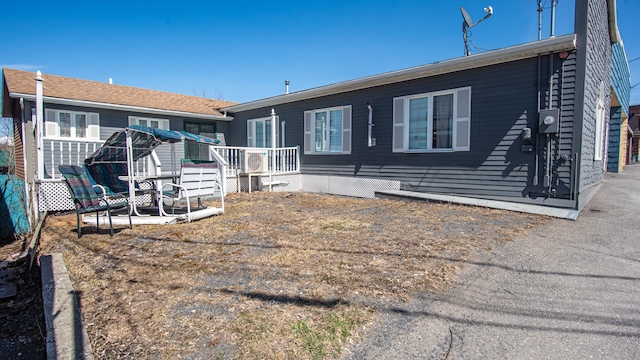 rear view of property with a wooden deck