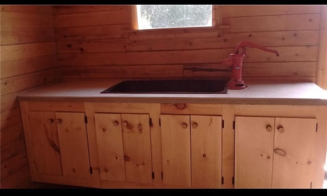 kitchen with light countertops and wood walls