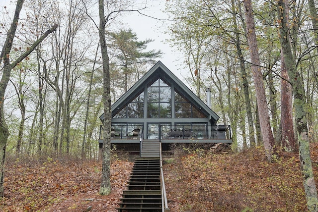 rear view of property featuring stairway