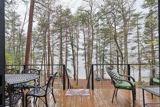 wooden terrace with outdoor dining space